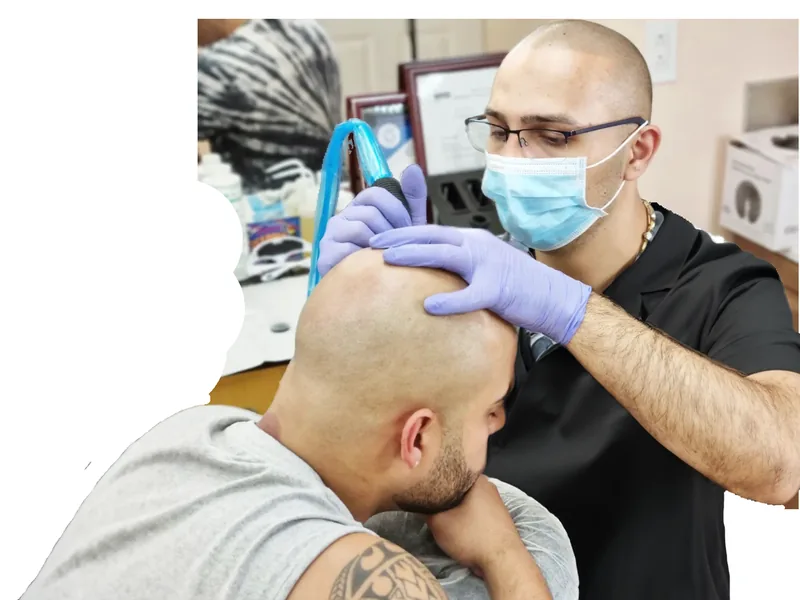 SMP practitioner performing scalp micropigmentation treatment in Queens